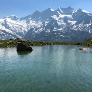 View of the Mischabel mountain range from the glacial lake at Kreuzboden - impressive Alpine panorama in summer